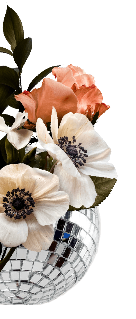 A bouquet of pink and white flowers with dark centers in a silver disco ball vase against a black background.