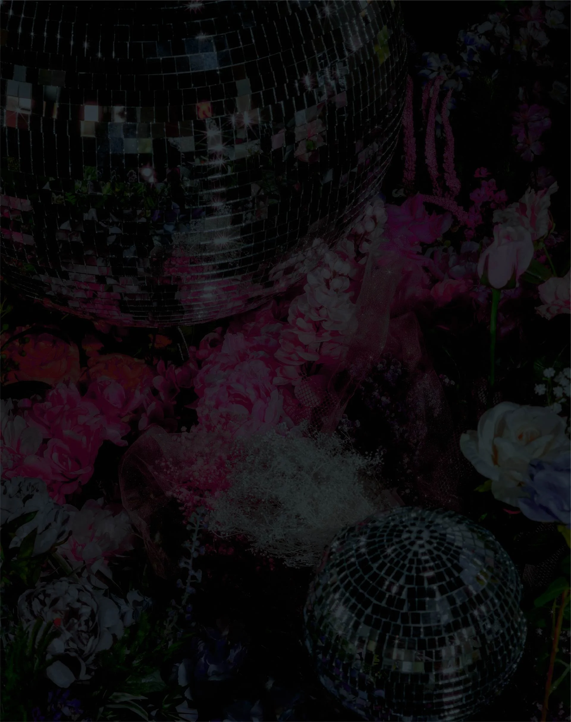 A shiny disco ball surrounded by colorful flowers.