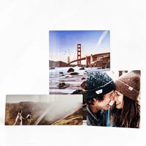 Three postcards featuring the Golden Gate Bridge, a couple in knit hats, and a landscape with a mountain and lake.