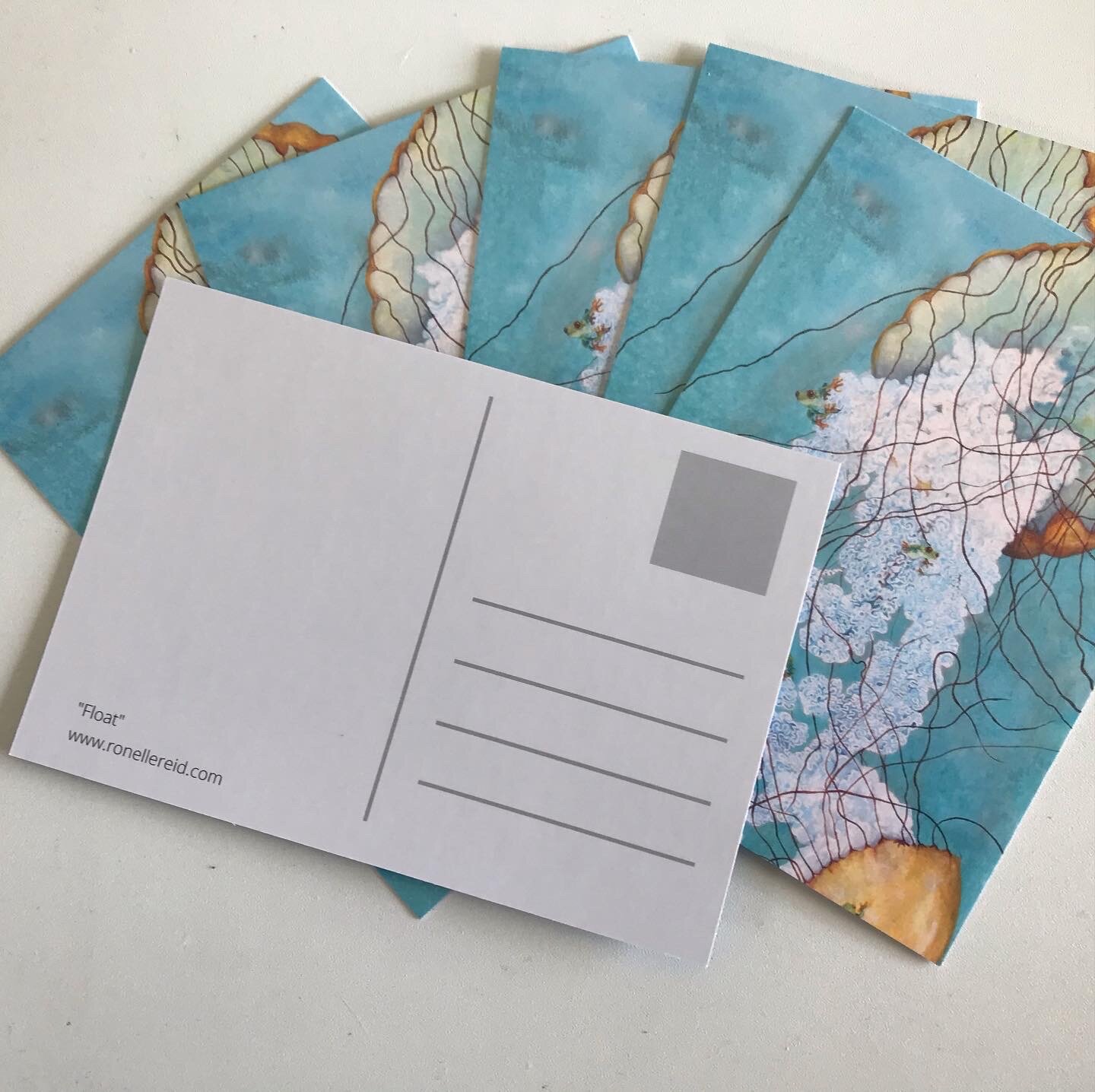 postcard depicting original artwork of jellyfish with frogs jumping around them