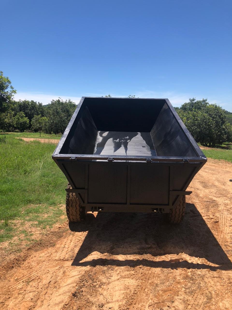 The perfect trailer to harvest Macadamias and dump husks. —