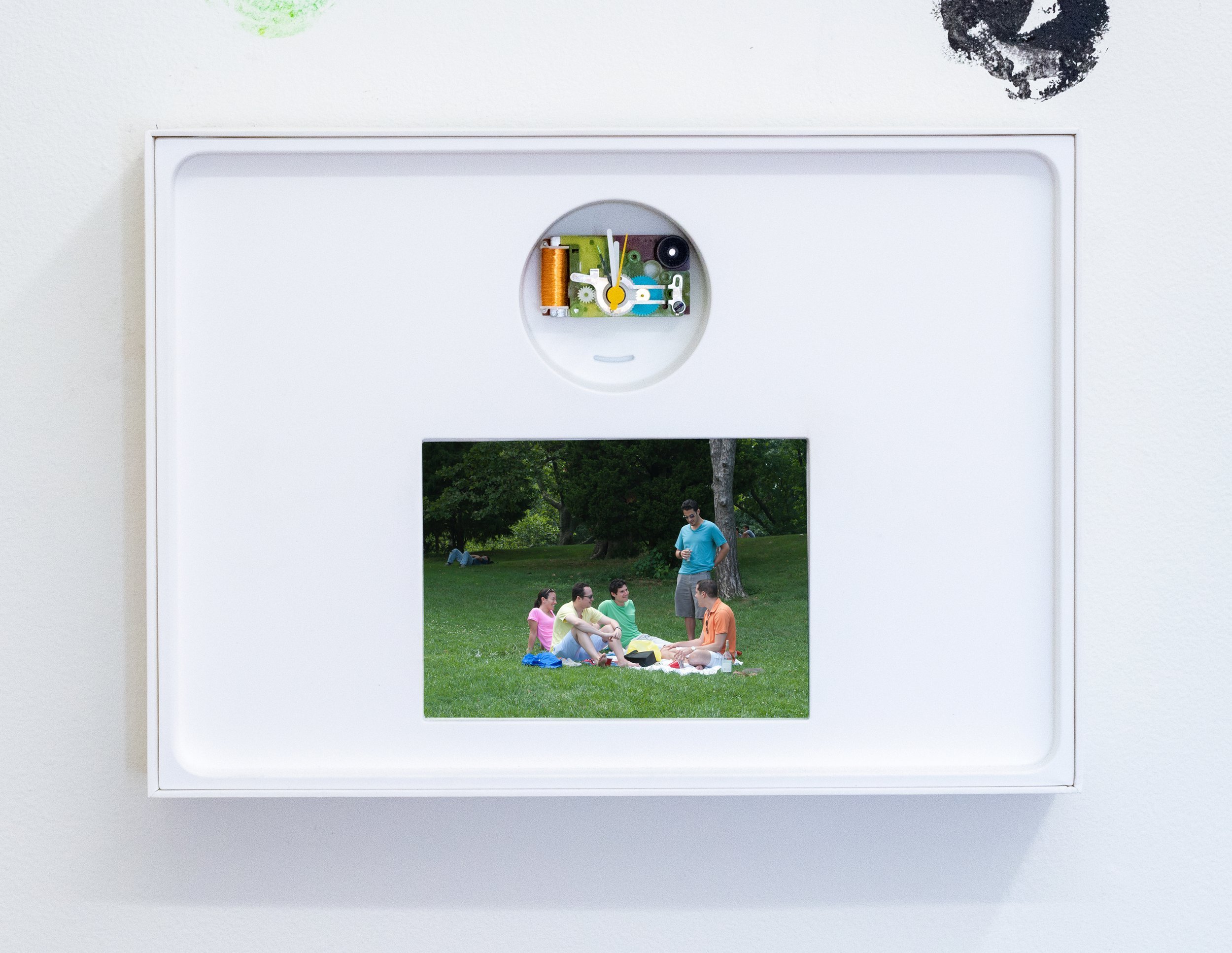 Lub Poeem | Untitled (The Picnic), 2022 | Pigment print, Braun AB 1 clock parts, Apple iPad box | 9 in x 12.5 in x 2.25 in (22.86 cm x 31.75 cm x 5.715 cm)