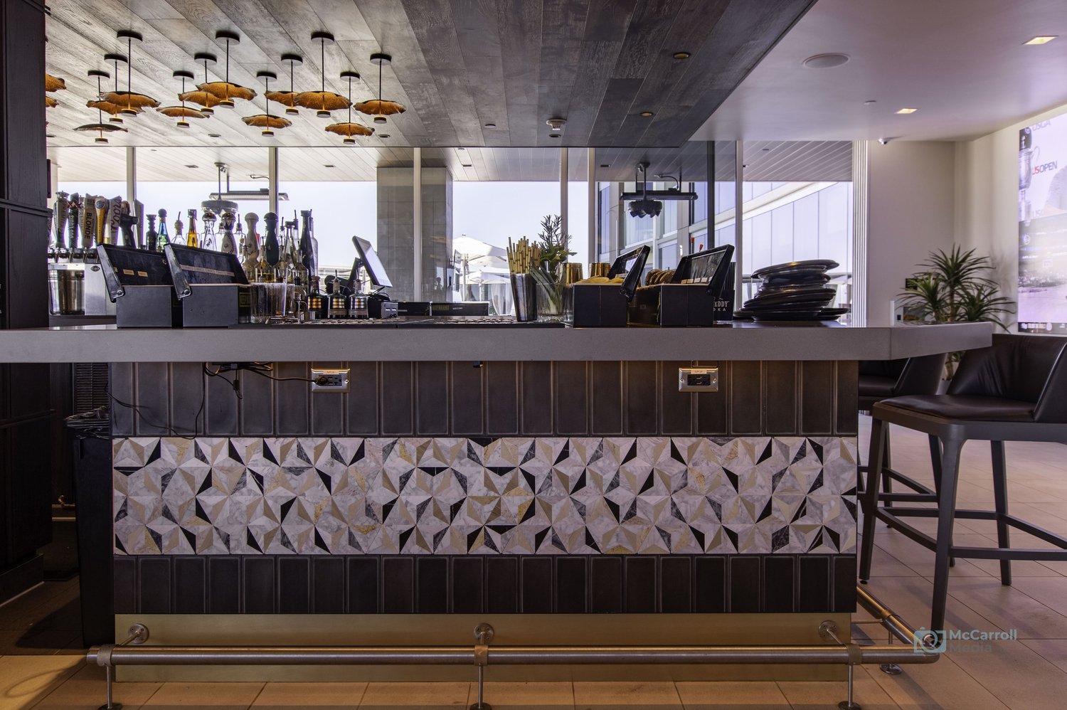 Bar front adds symmetry, materials, and hospitality context.