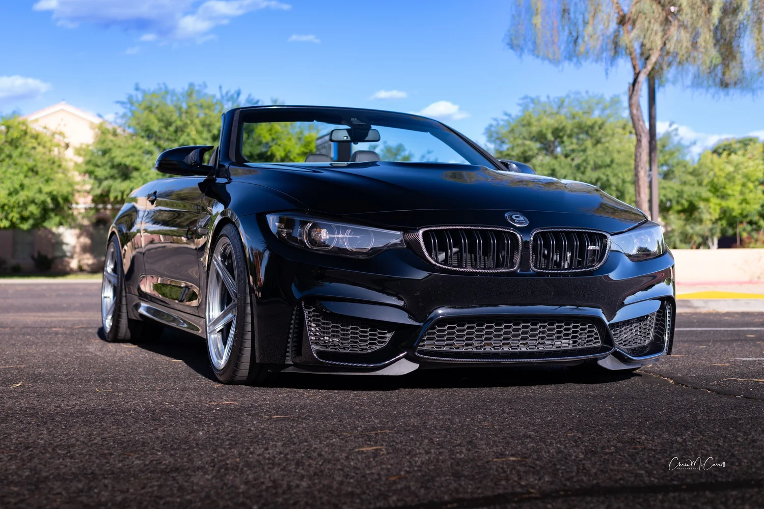 Black BMW convertible photographed from a low three-quarter angle