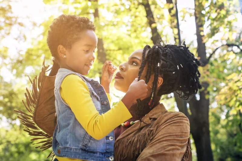 A stock photo of a mother holding a child.