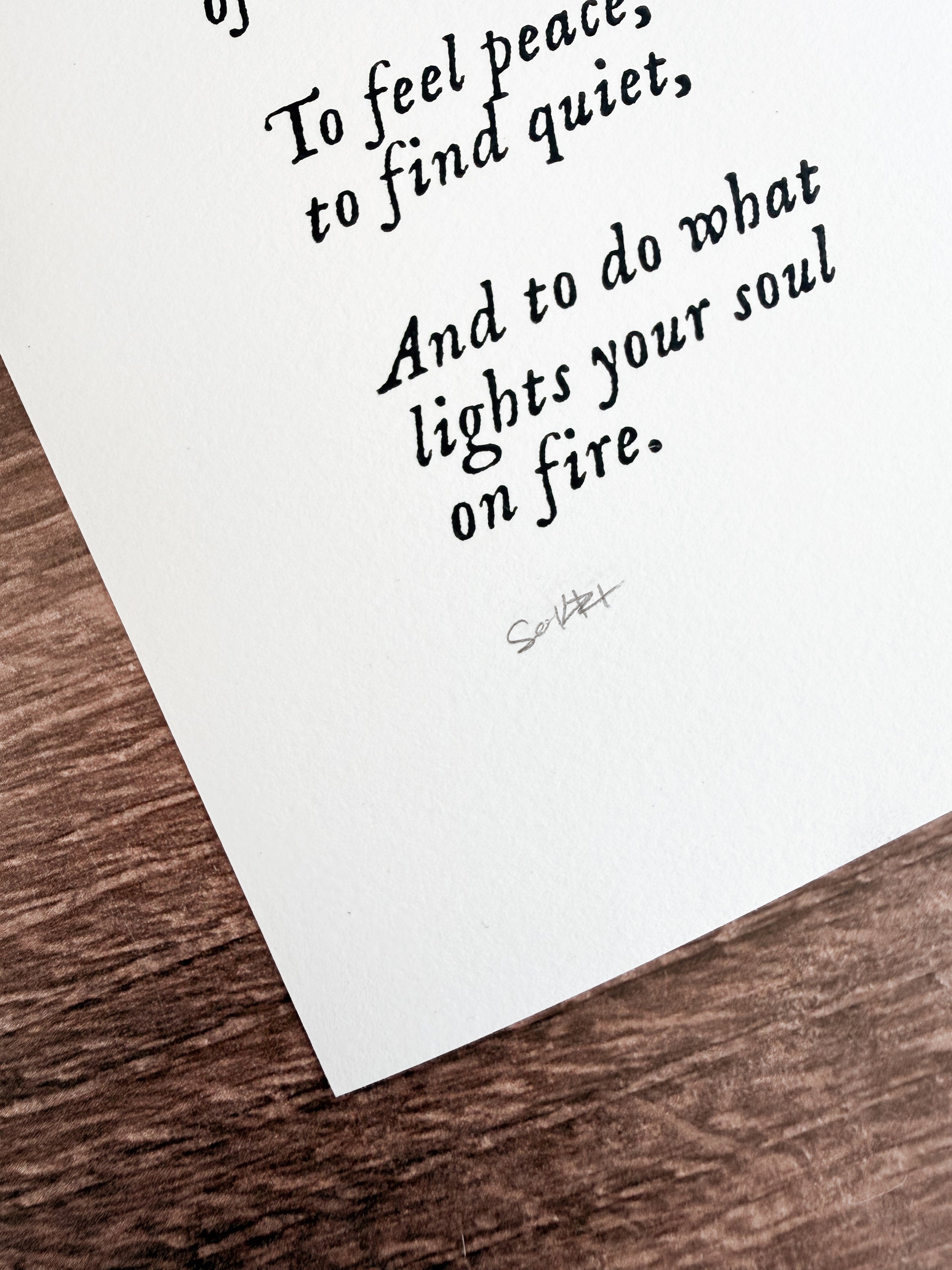 Close-up of hand-printed benediction text reading to feel peace and find quiet on cotton paper