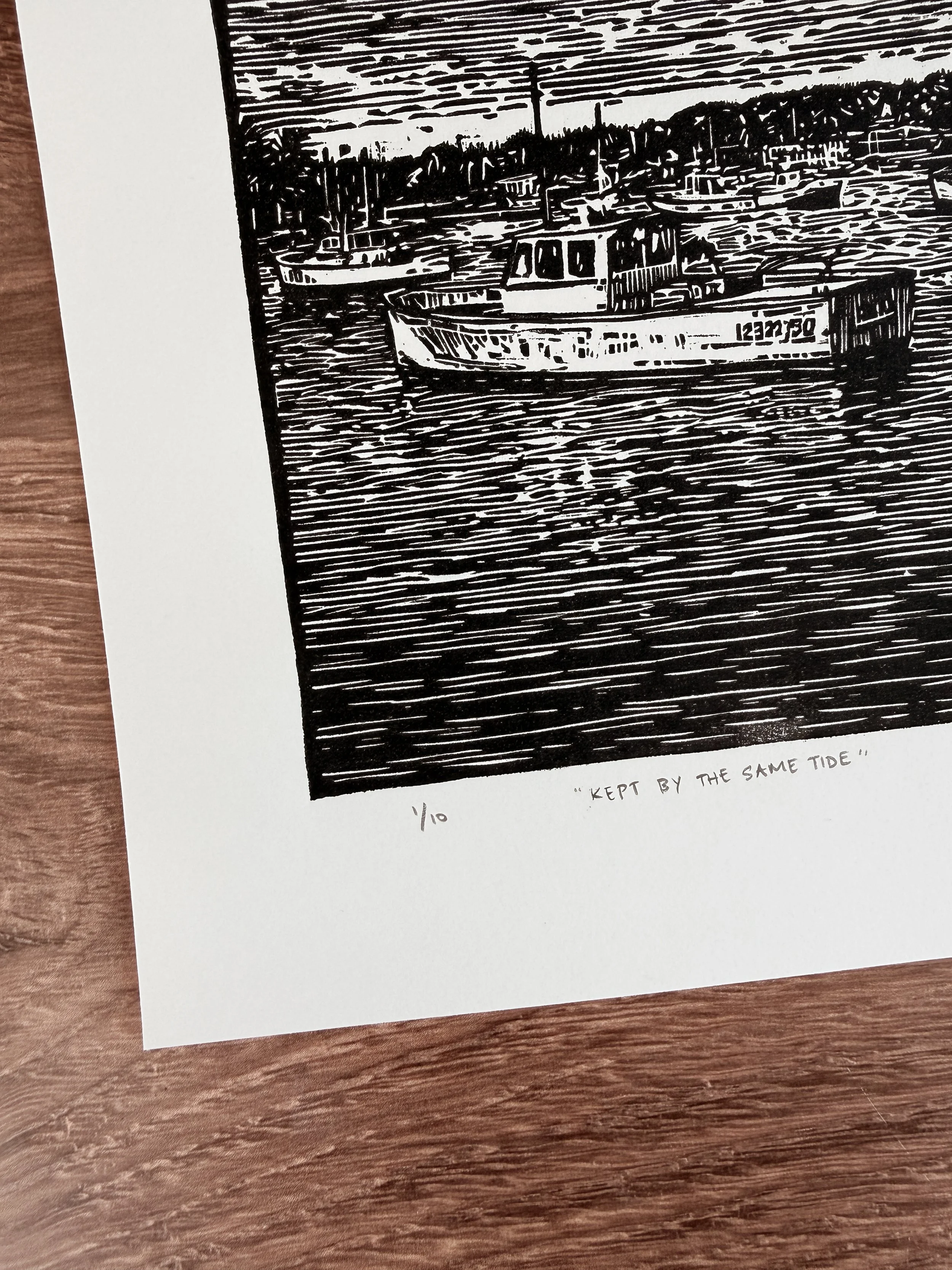 Close-up of linocut print showing harbor boat and water texture titled Kept By The Same Tide