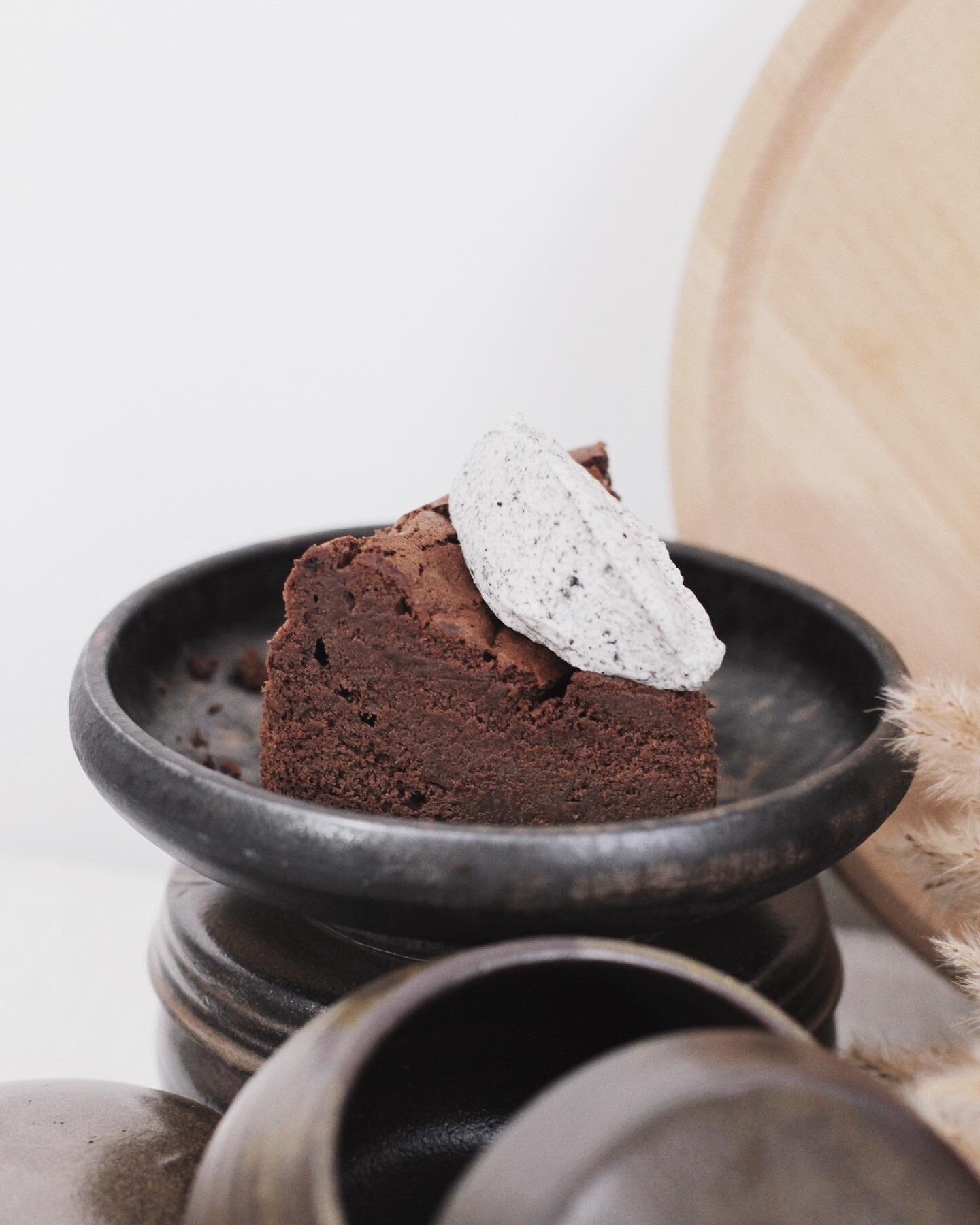 Our flourless dark chocolate cake is luscious, soft, and eats like a ganache. Topped with black sesame doenjang creme chantilly for a touch of umami earthiness.