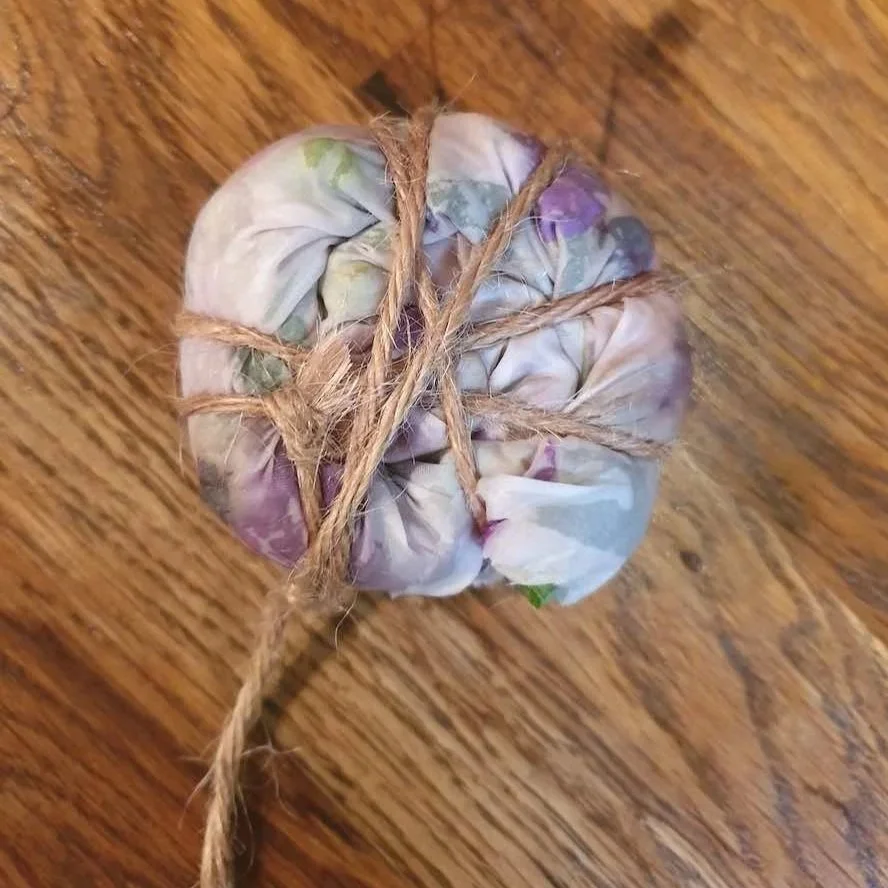 Rolled up silk scarf tied with hemp string.