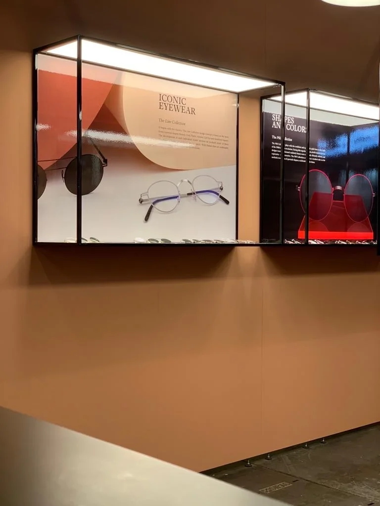 Edle Messestandsvitrinen mit LED-Leuchtflächen für eine gleichmäßige Produktausleuchtung und einem Kampganenbild als Hintergrund.