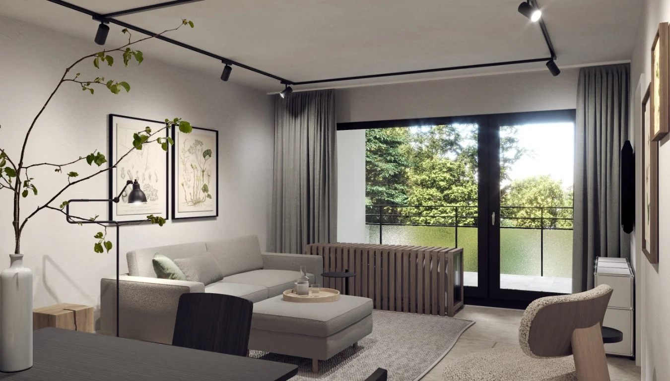 Sitzecke mit Aussicht auf den Balkon und den grünen Innenhof. Individuelle Heizkörperverkleidung als Bank vor dem Fenster.