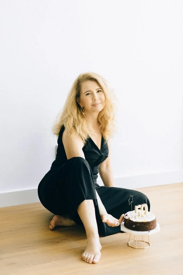 woman sitting on the floor with cake
