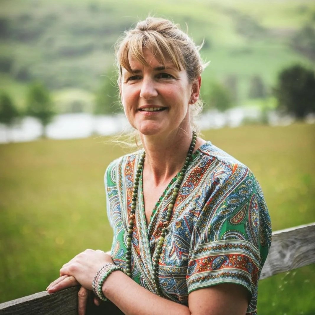 woman standing by gate smiling