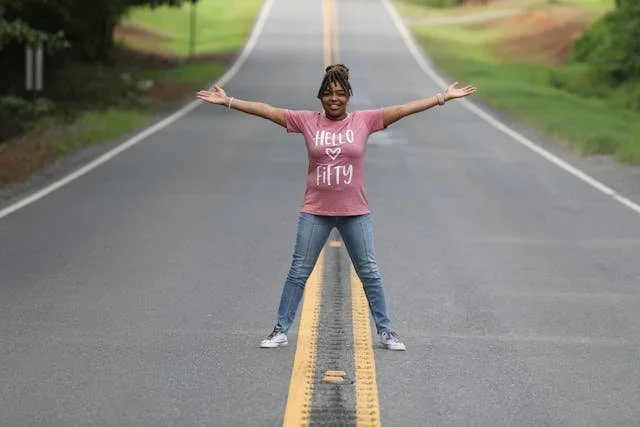 woman celebrating on open road