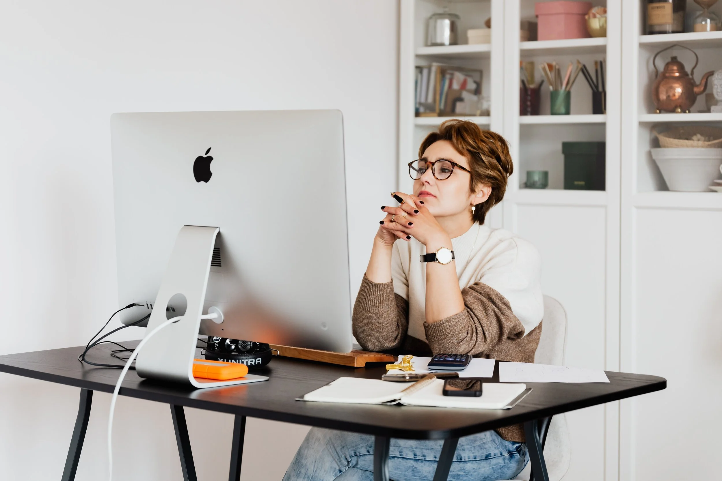 woman at desk talking at desk top