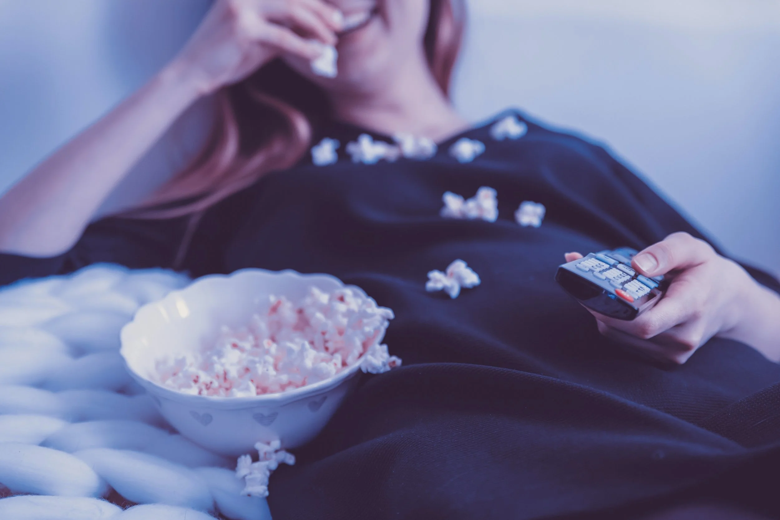 woman remote popcorn