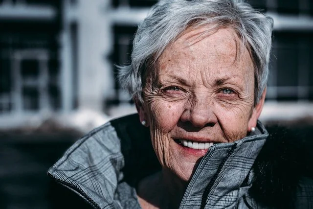older woman smiling into camera
