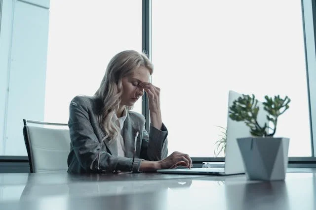 stressed woman sitting at desk