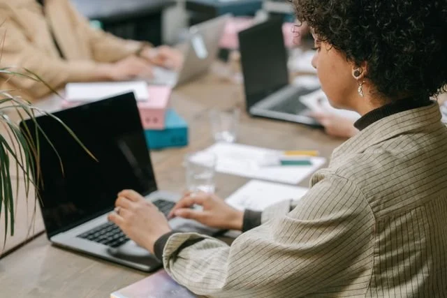 woman with curly hair at laptop