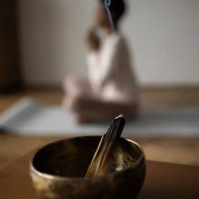 woman sitting with singing bowl