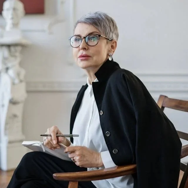 woman sitting writing in pad