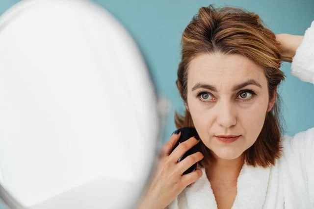 woman looking in mirror