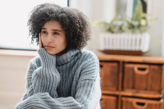 woman sitting looking depressed