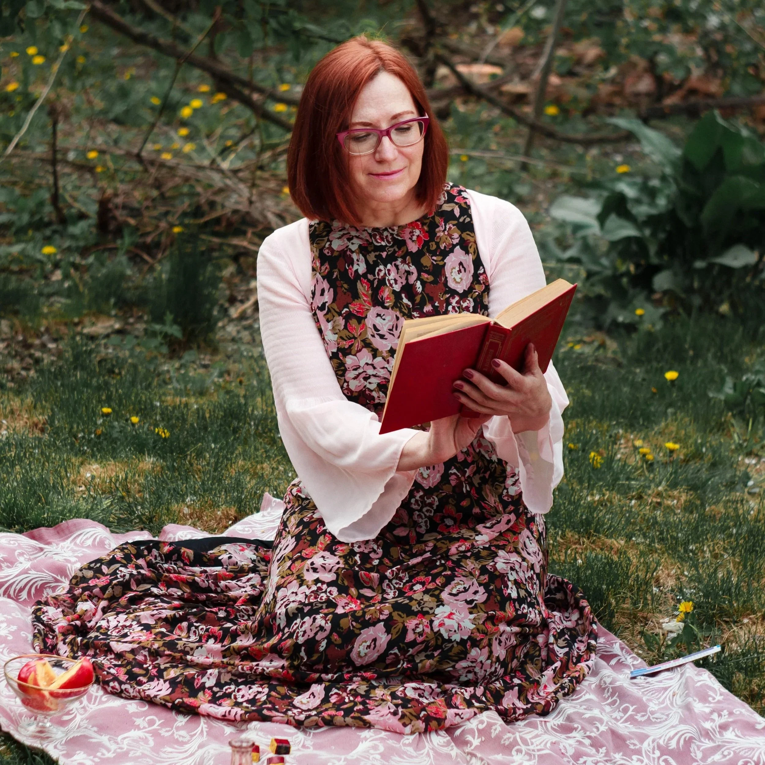 woman in a field reading