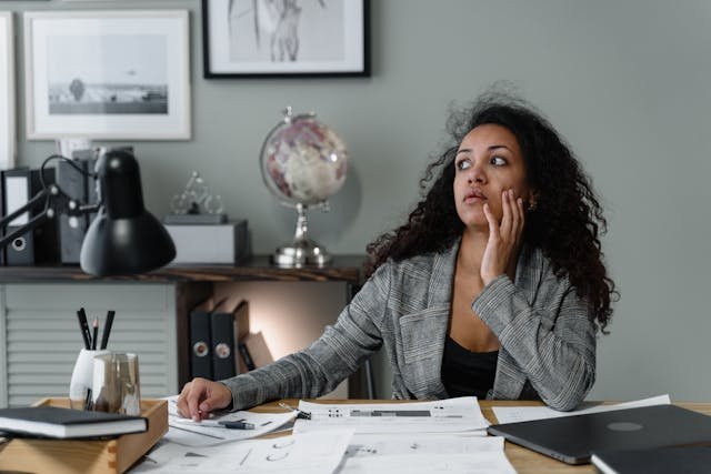 woman sitting working looking confused