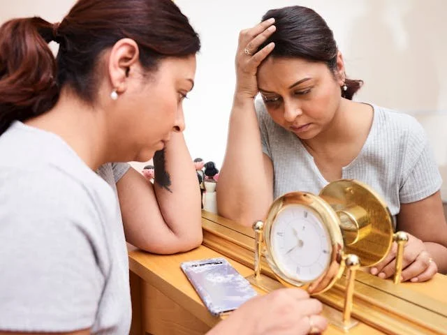 tired woman looking in mirror