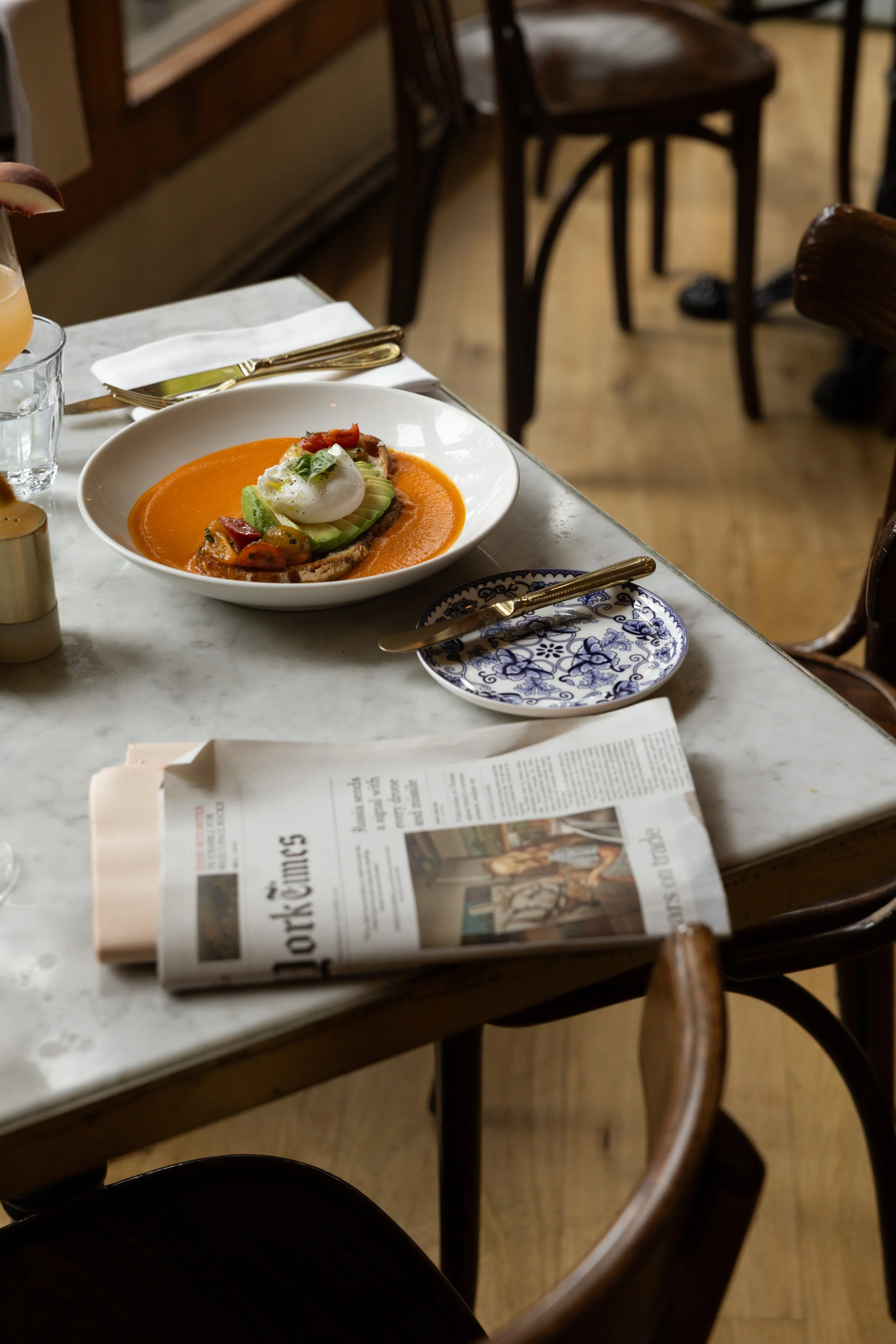 Plated seasonal dish served at Bianca restaurant in Culver City, set at a dining table with place settings.