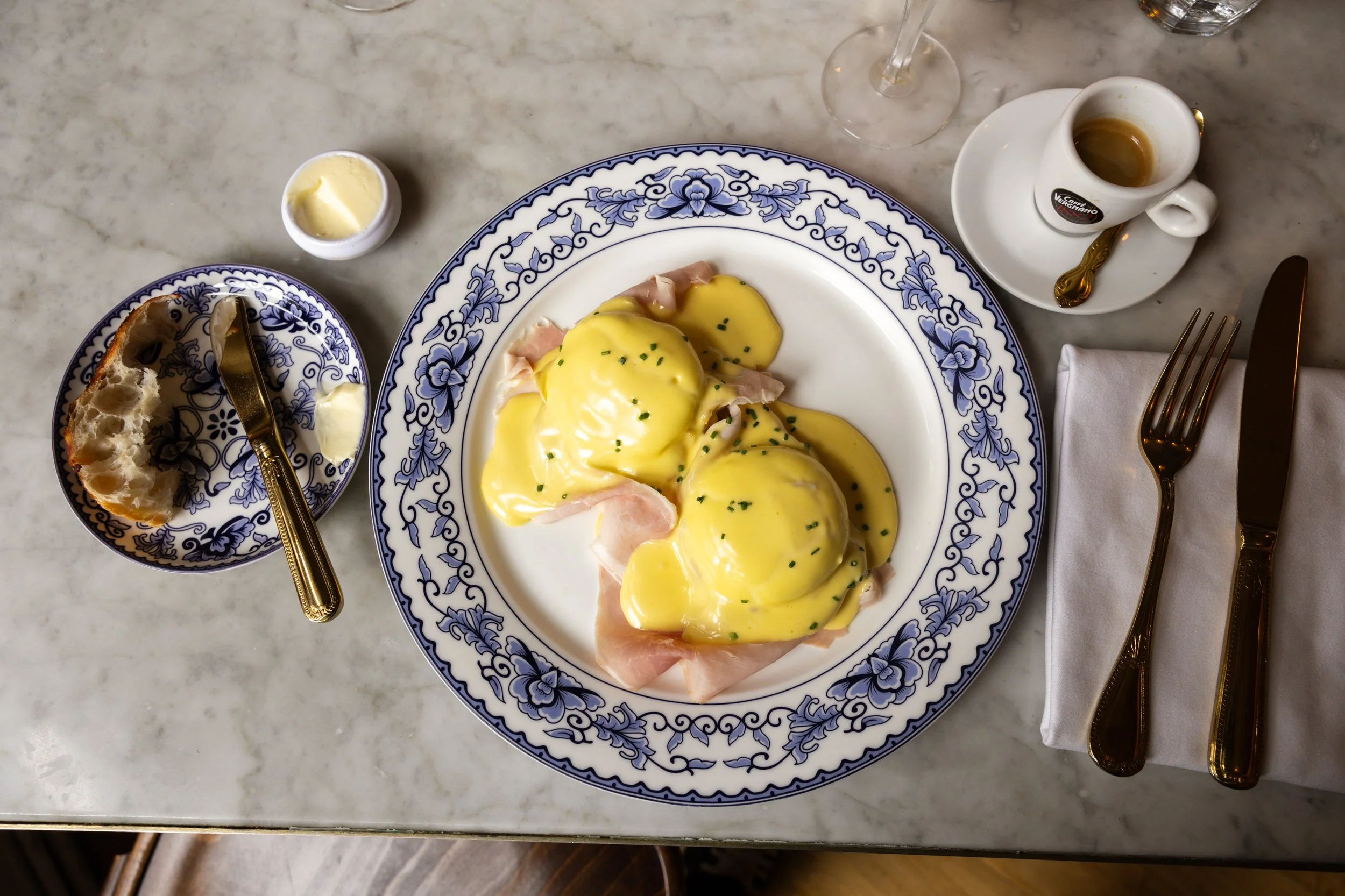 Plated Eggs Benedict dish served at Bianca restaurant in Culver City, presented on patterned tableware.