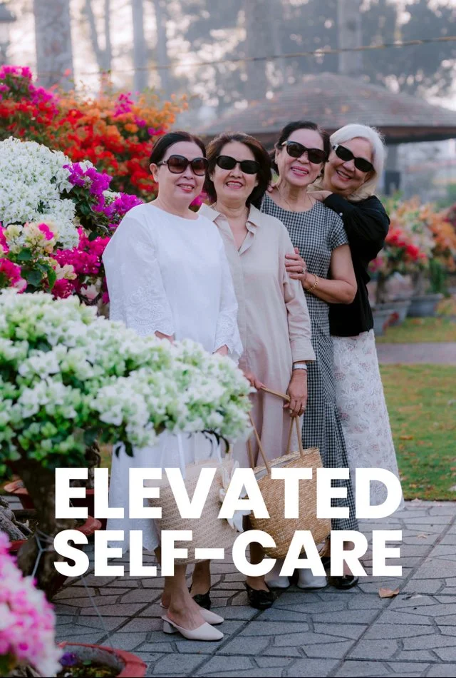 four midlife women dressed semiformally pose at a botanical garden