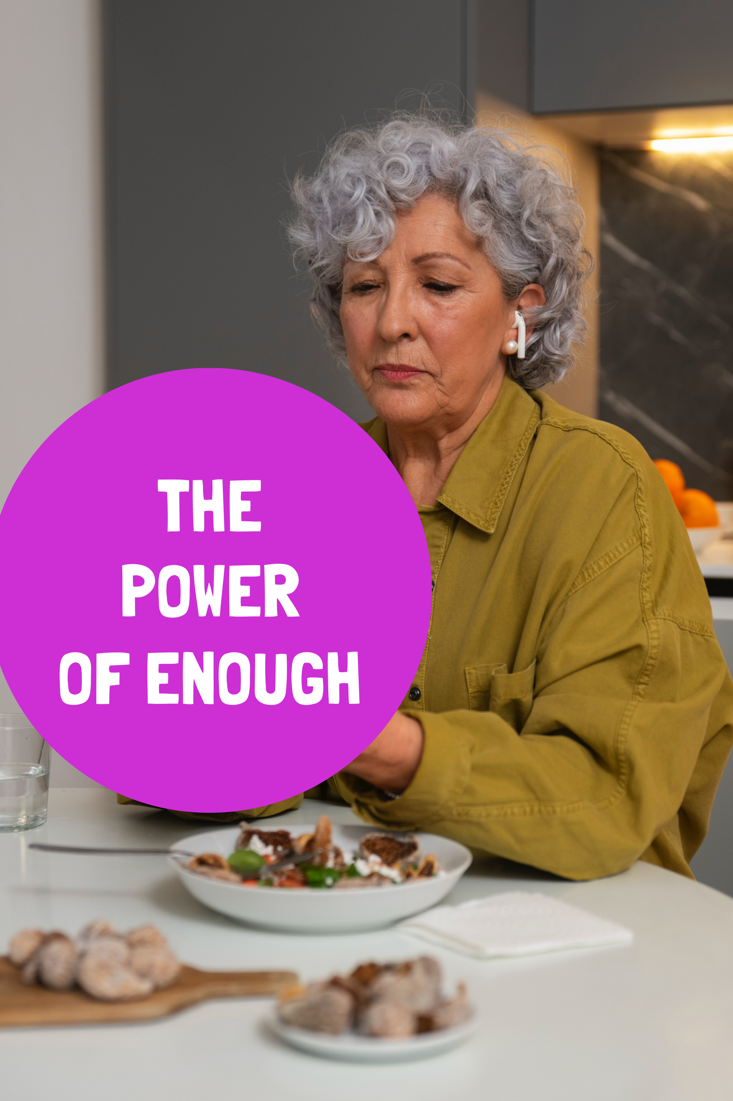 curly silver haired white woman wearing an olive jacket contemplates her food and portion sizes.