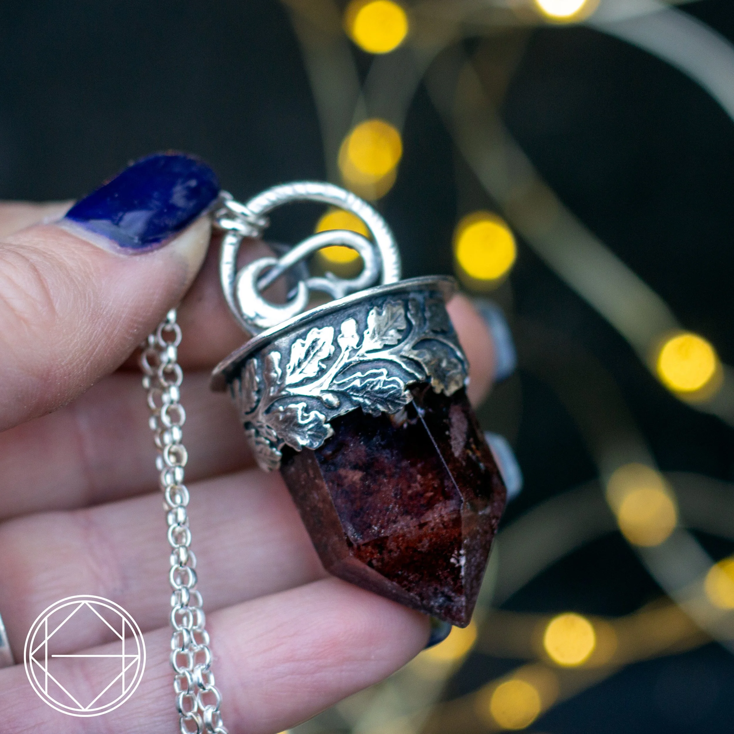 A beautiful detailed Garden Quartz point necklace with a moon accent