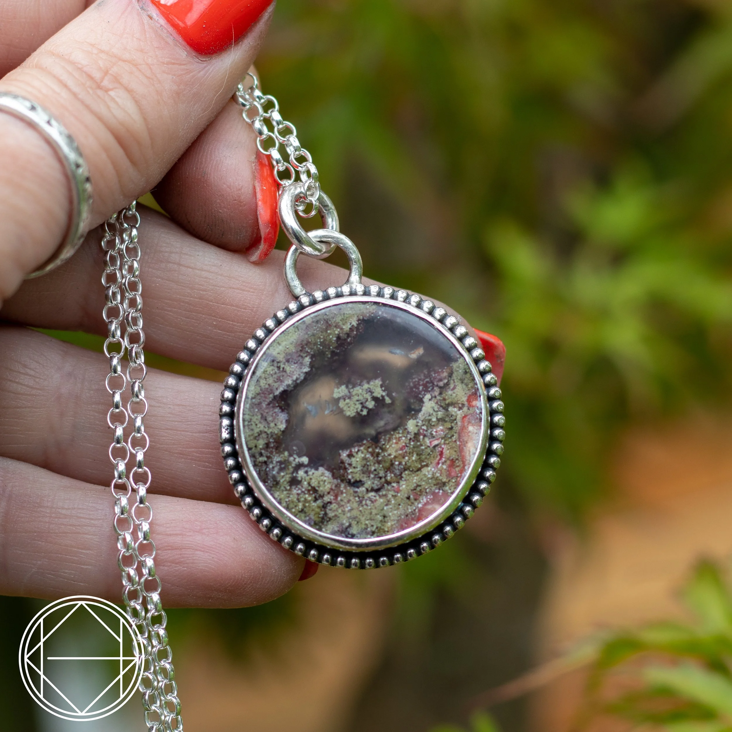 a beautiful large circluar Moss Agate crystal with silver edging