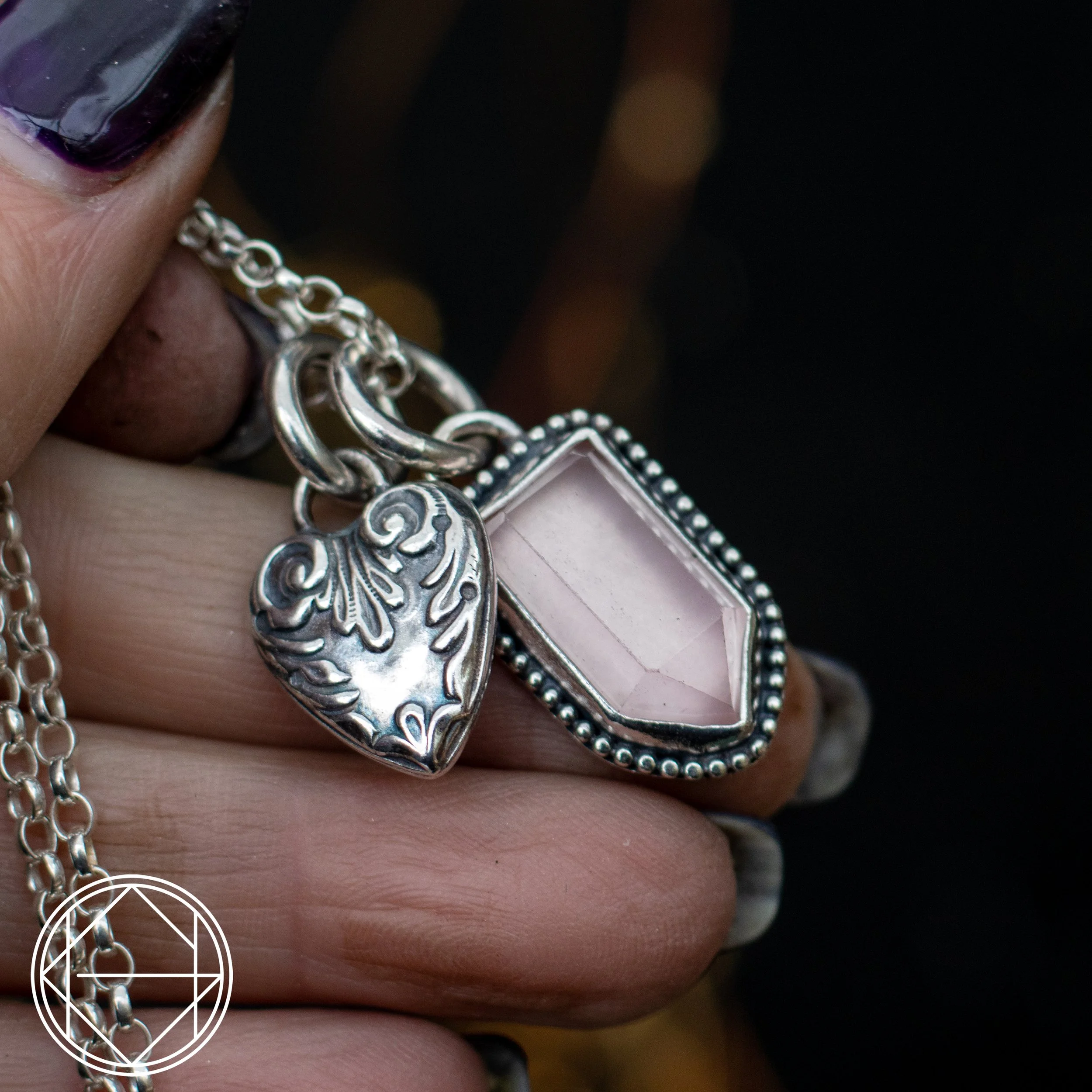 storyteller necklace featuring a Rose Quartz charm and silver heart