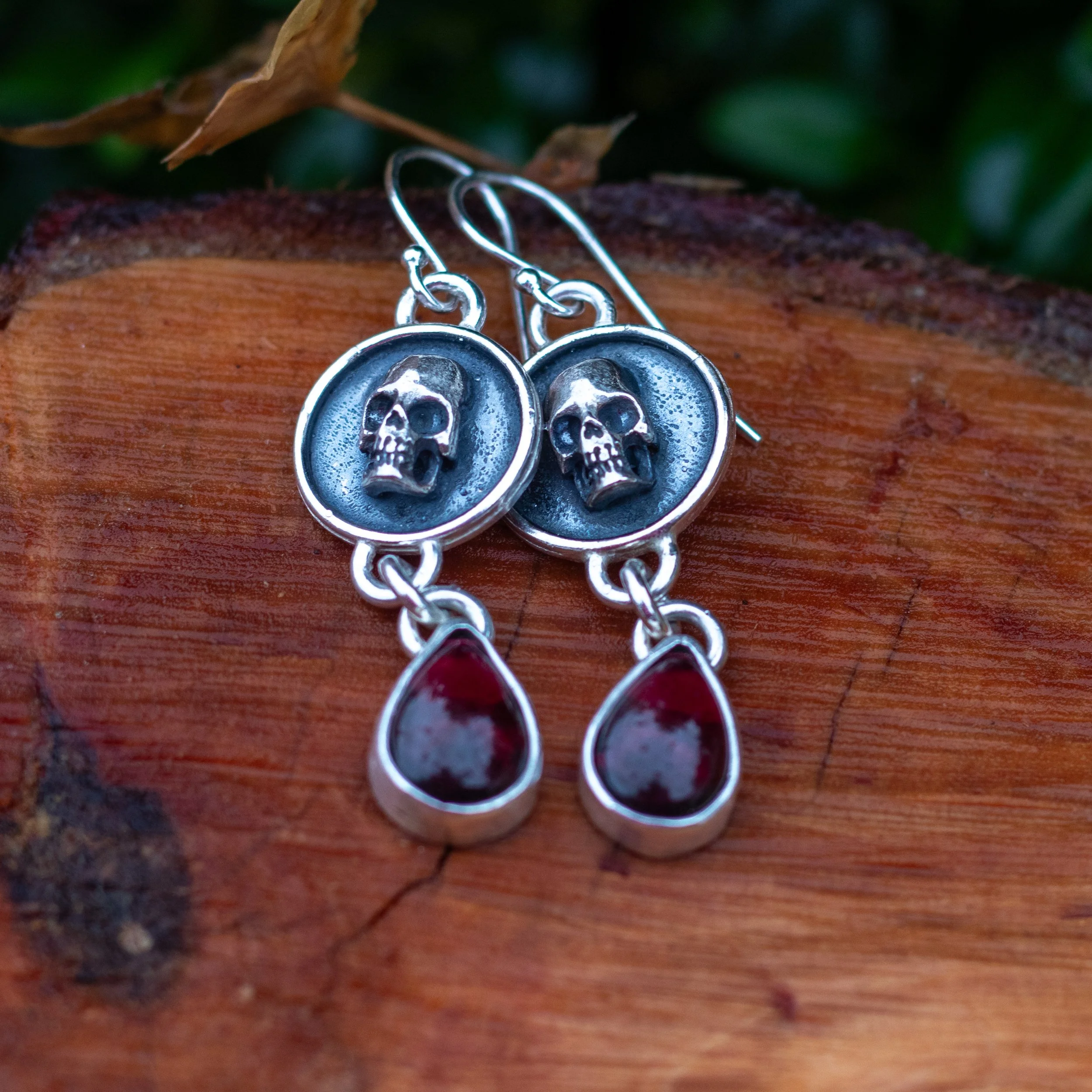 Eye catching shadow box skull with dainty little garnet teardrops swinging below sterling silver hooks by Gemheaven Jewellery