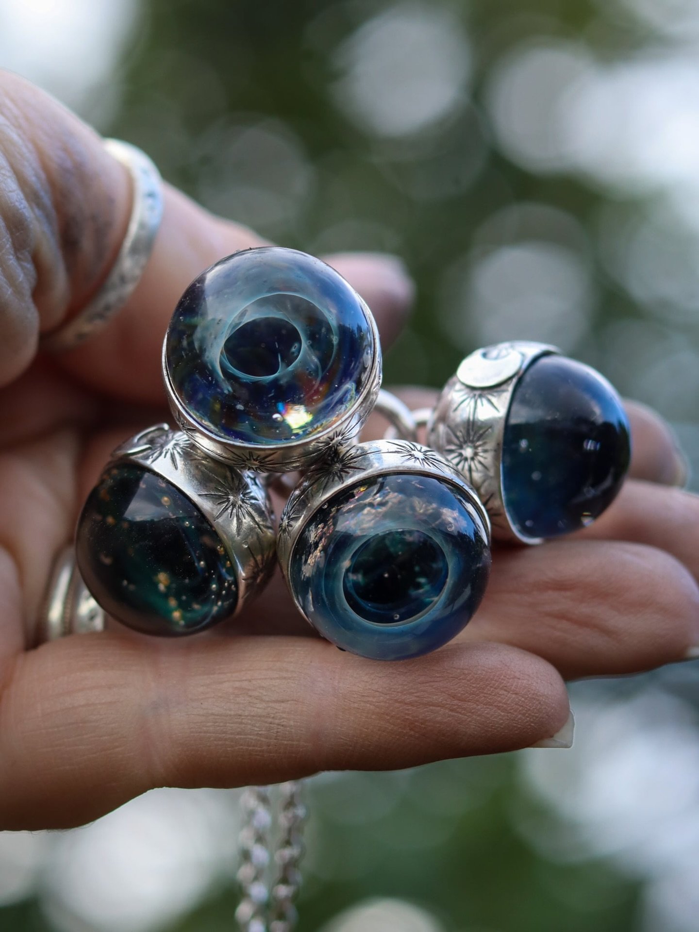 Magical Galaxies captured in glass encased in Silver, the distant stars answering an ancient call.  Does the Cosmos call you too? 

These were the ones that left recently although I&rsquo;ve had word one is being returned to me so  keep an eye open f