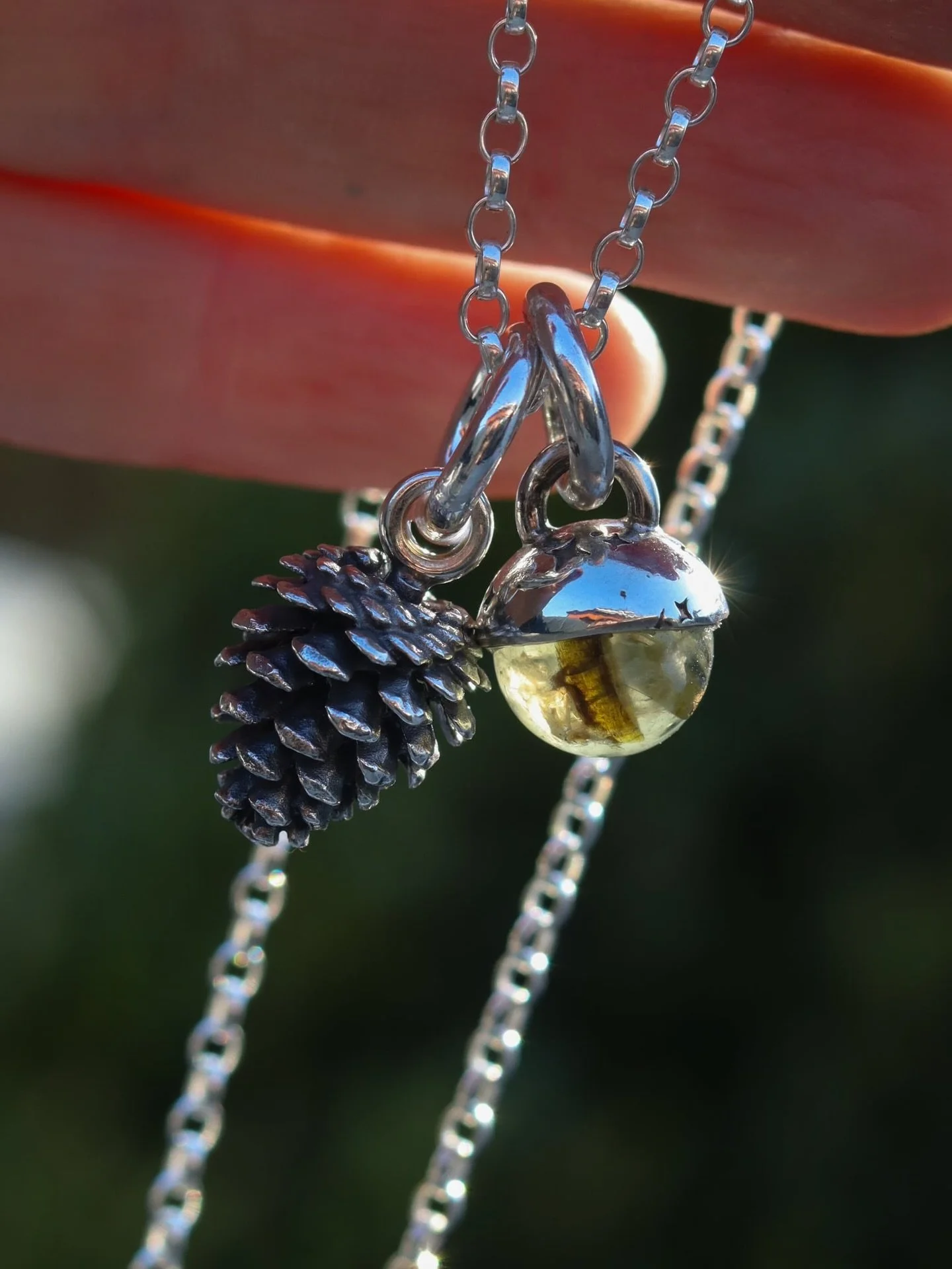 This little woodland Storyteller Collection Set carrying the spirit of the forest, a cast sterling silver pinecone paired with a glowing prehnite sphere cradled in its silver cap.

A charm for grounding.
A charm for ancient wisdom.
A charm for those 