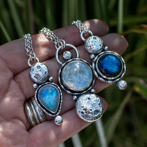 A beautiful chunky sterling silver pressed full moon - look at all the details!! A flashy moonstone surround in fancy wire with a tiny moon  below.