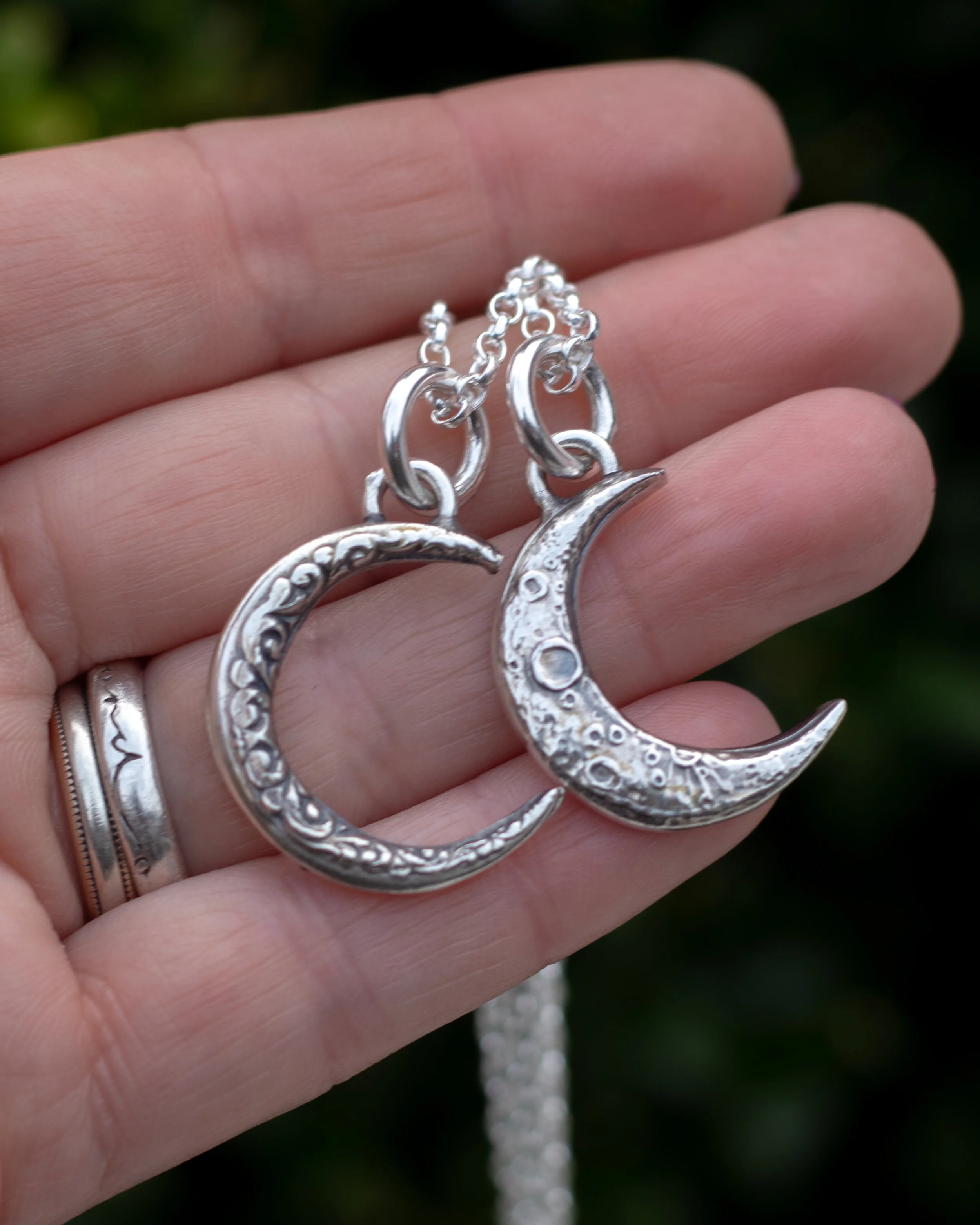 Two silver  moon pendants