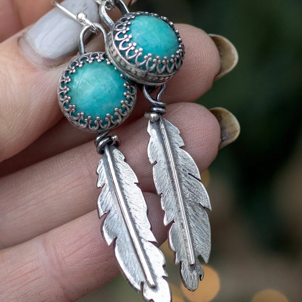 Pair of earrings with amazonite sphere enclosed in silver with a silver feather