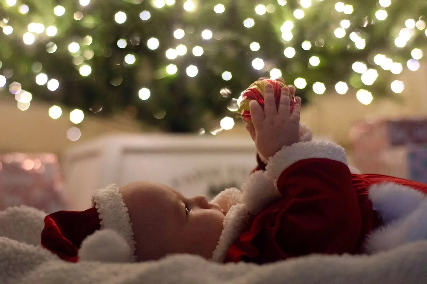 Perfect little profile and tiny pudgy knuckles 🥹 baby's first Christmas