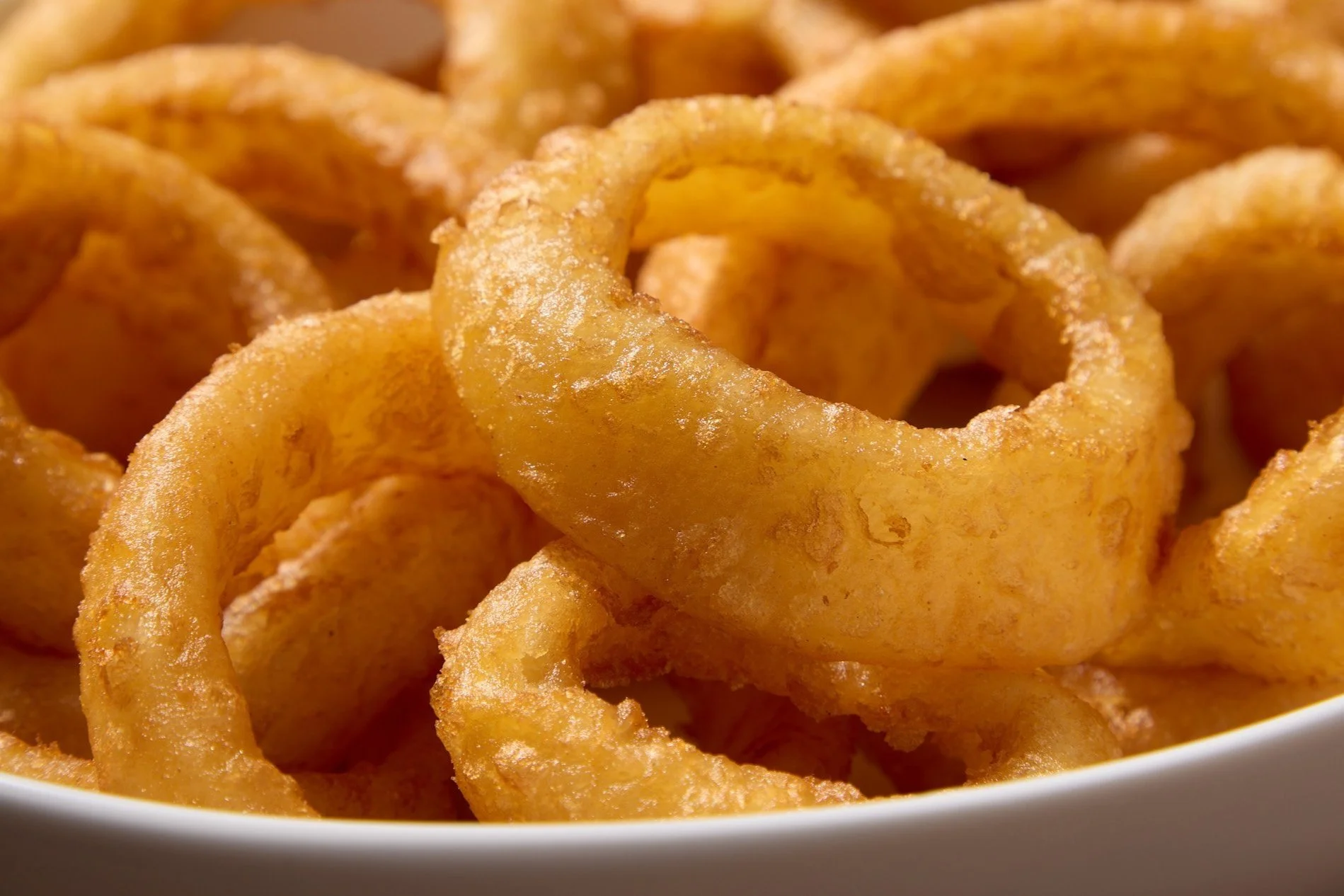 Closeup of beer battered fried onion rings. 