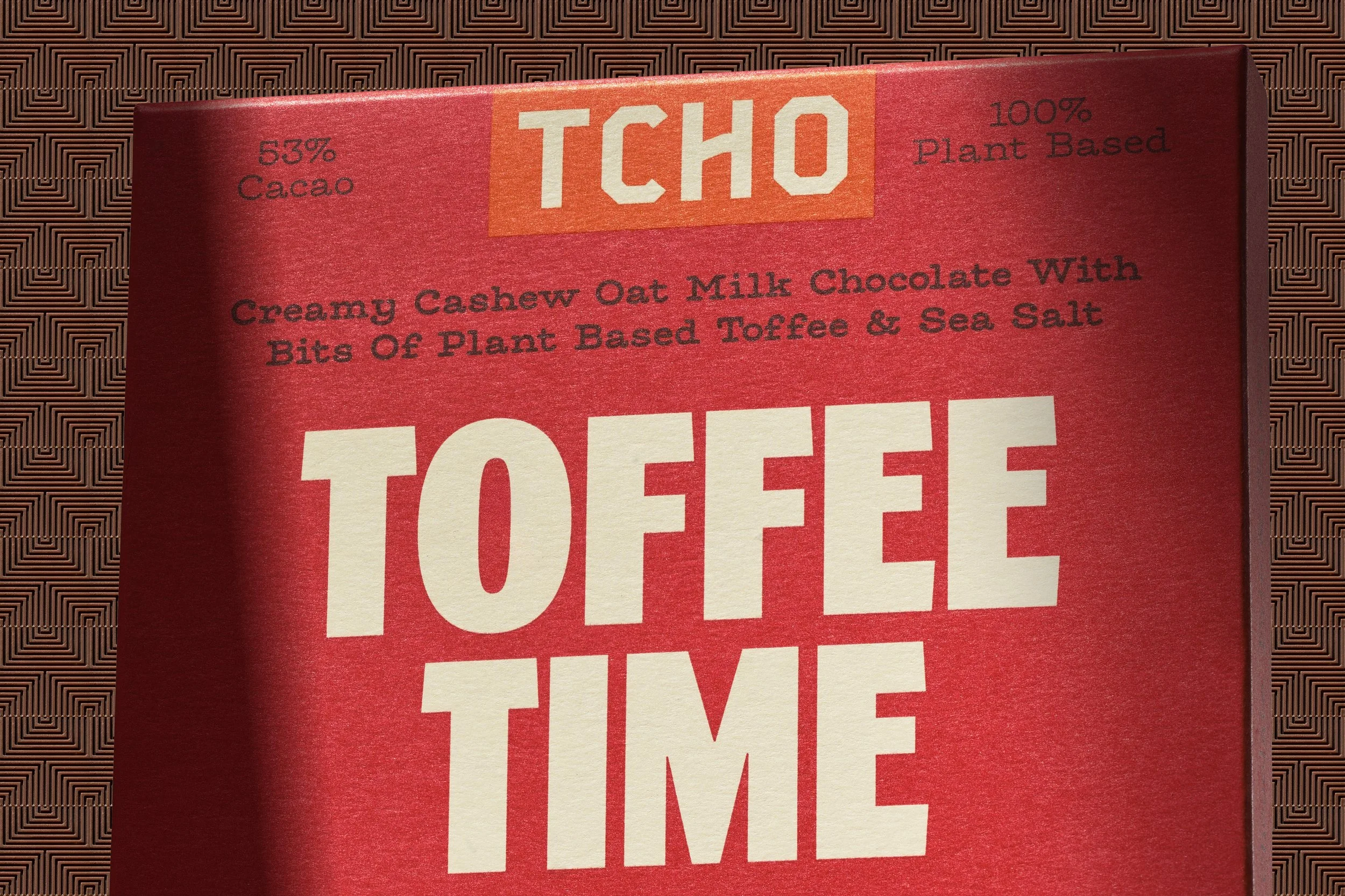 Close up of a package plant based chocolate. TCHO, toffee time with dramatic lighting and shadows. 