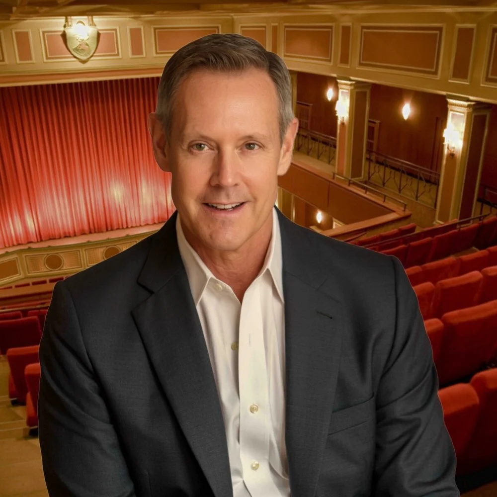 A photo of Charles D. Urstadt in front of the Belasco Theater in New York.