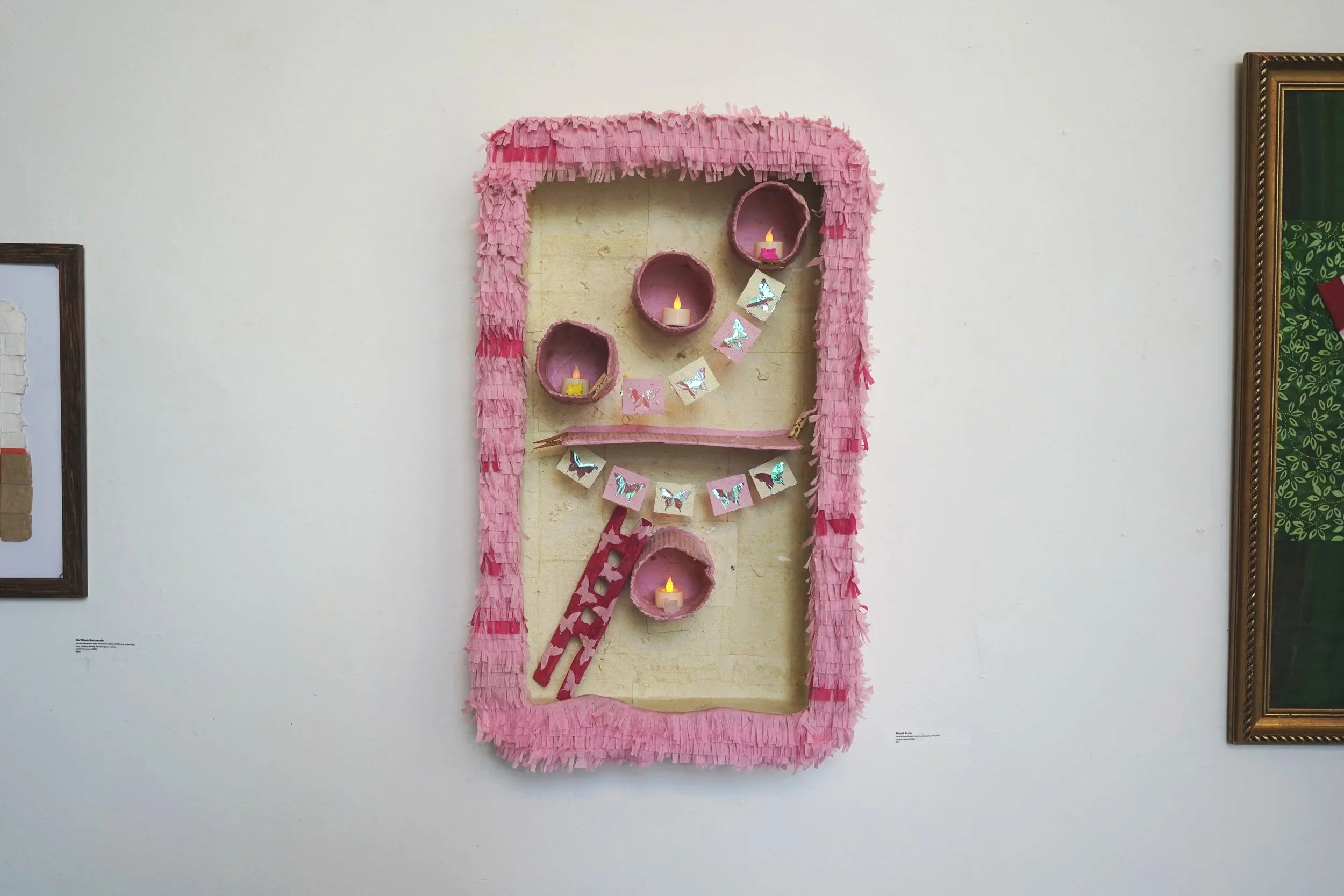 "Ritual Ache", handmade recycled paper, cardboard, streamers, candles, 18x30in, 2025
