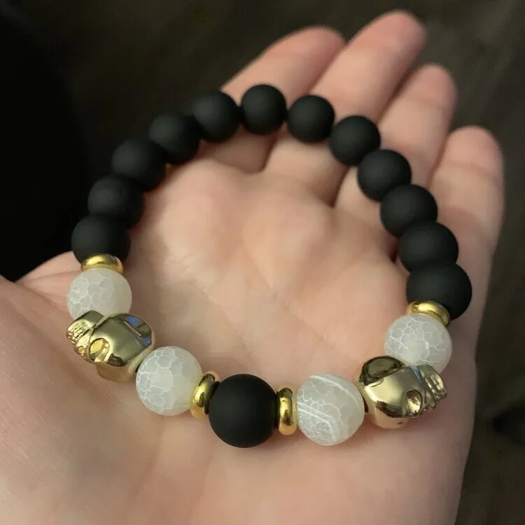 29. 10mm beads: matte black glass, frosted crackle agate and gold hematite skulls