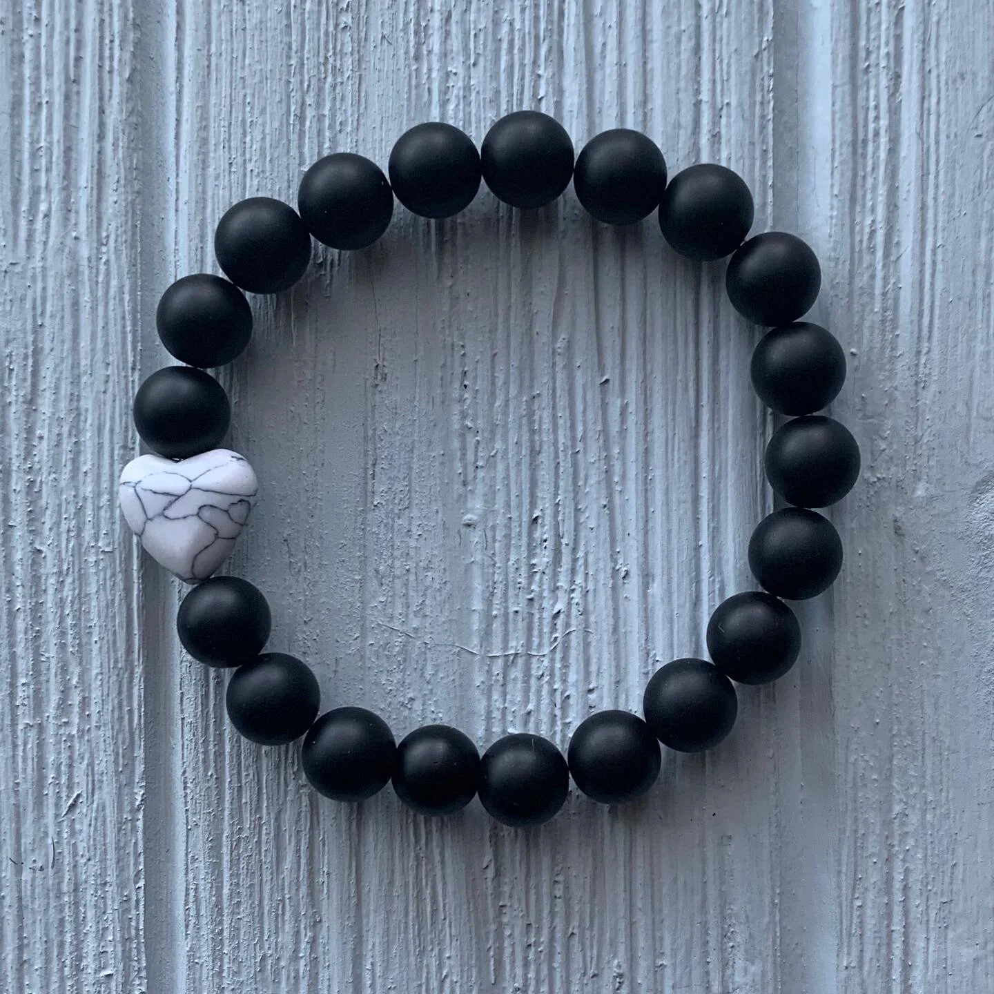 68. Matte black onyx and howlite heart bead | $20.00